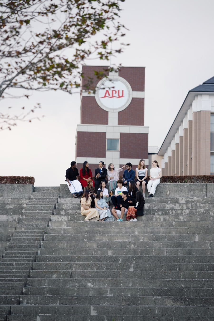 Impactional members gathered on the steps at Asia Pacific University