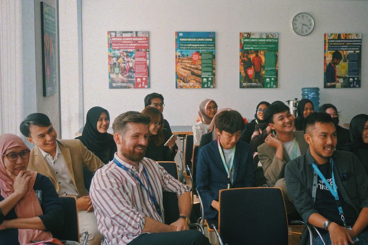 Participants smiling together during an Impactional workshop
